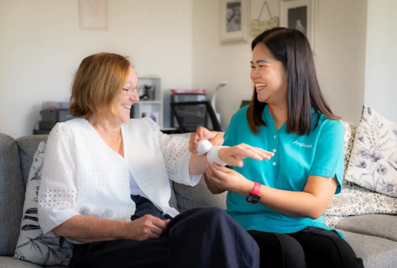 personal care and hygiene worker helping bandage wound.
