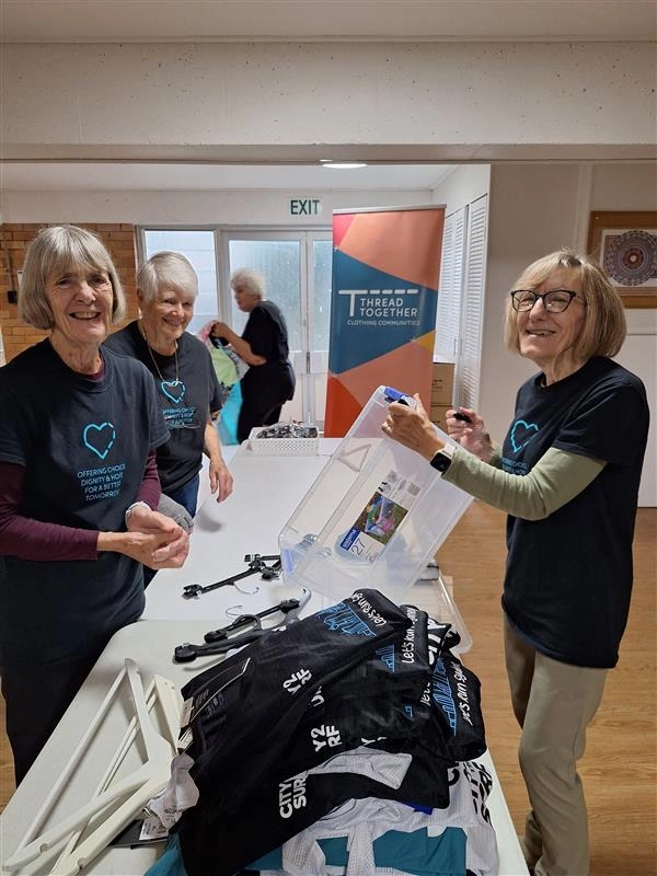 Thread Together Volunteers smiling at camera