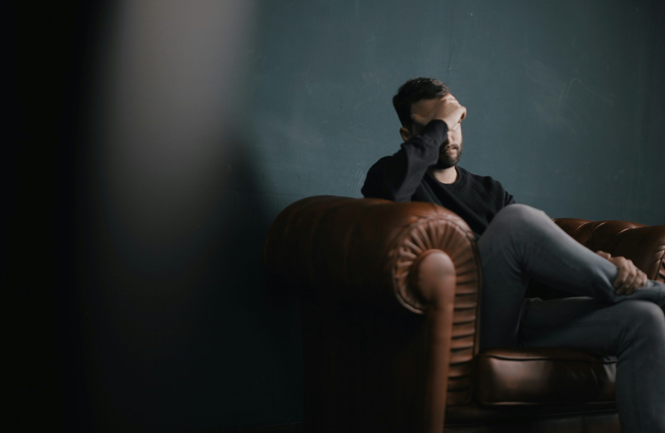 Man sitting on a couch with anxiety