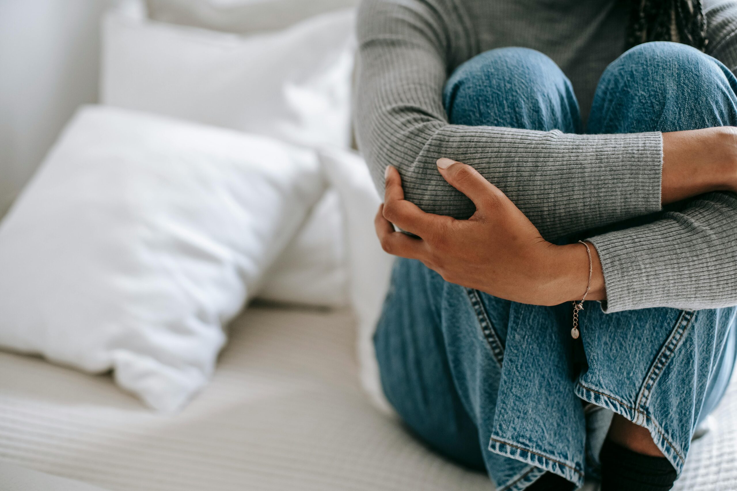 Woman in crisis holding onto herself to calm herself down