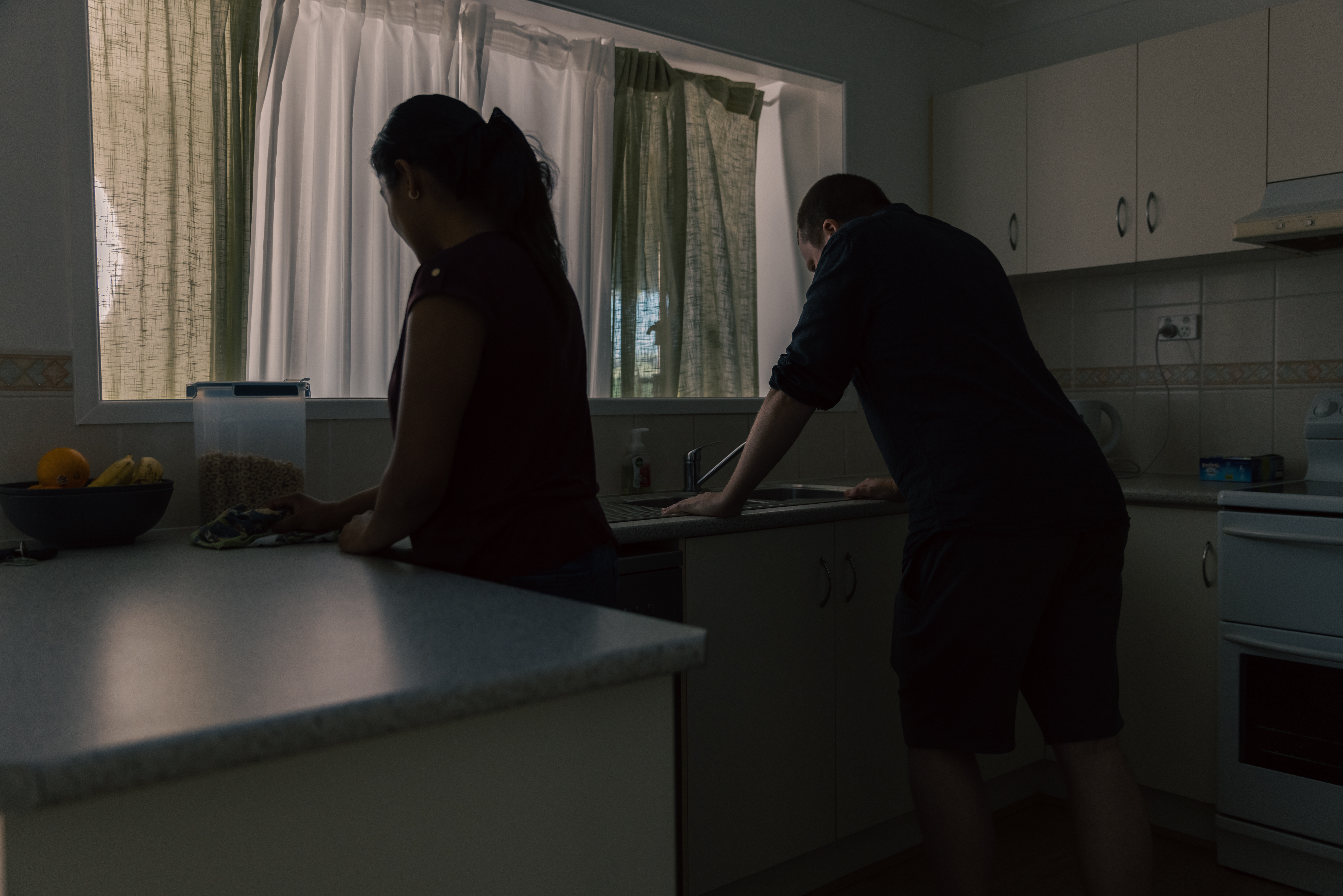 Myths about anger blog. Image of man looking angry in kitchen with partner.