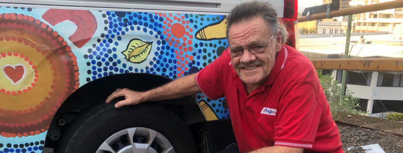 Rob Main, Support Service Worker, kneeling down next to a tyre
