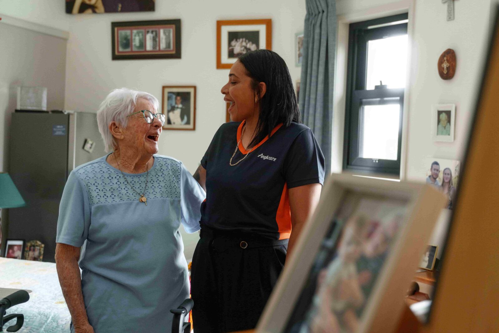 Anglicare personal care worker and client smiling at each other