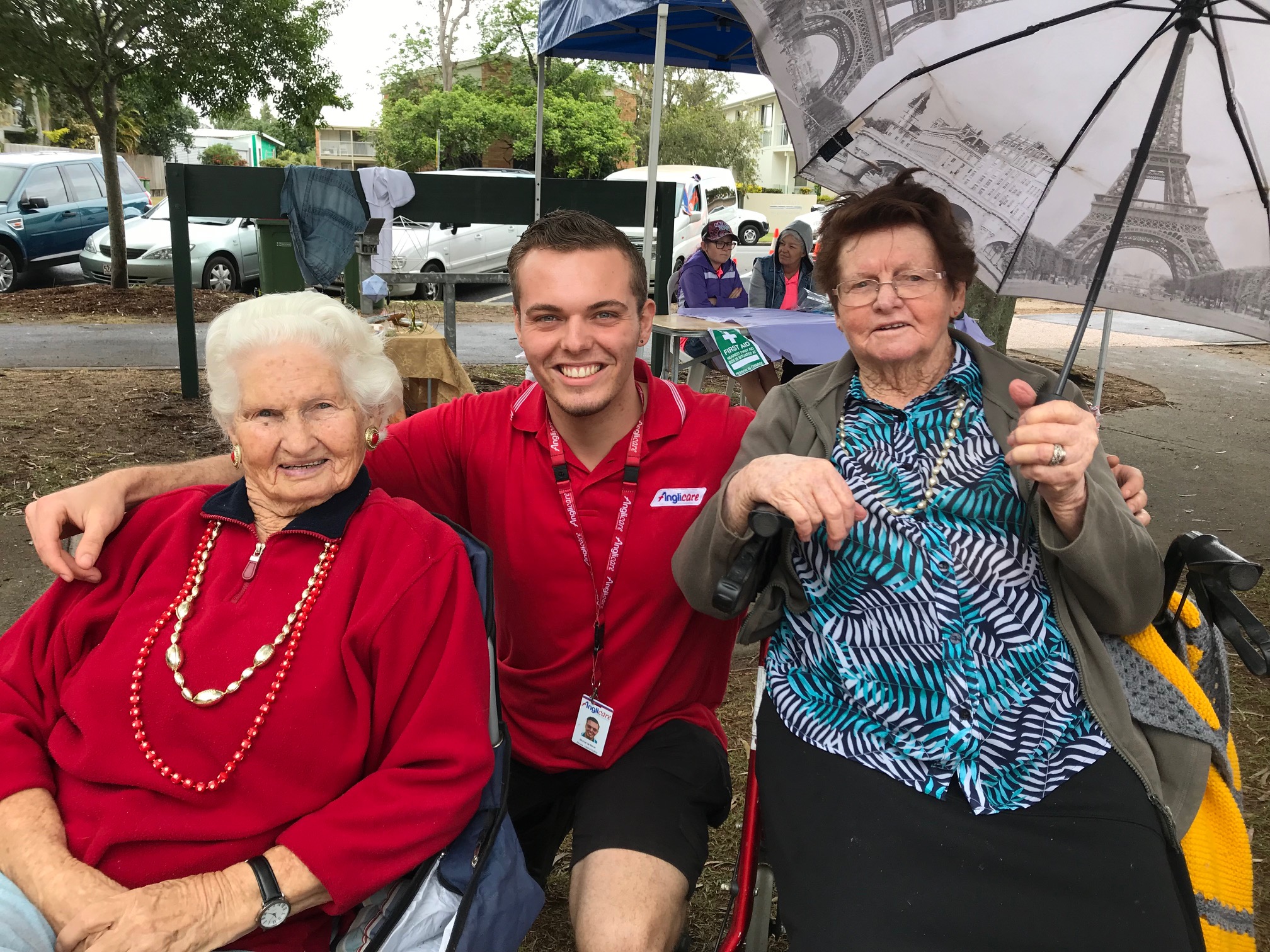 Staff member and two elderly female clients posed for photo at Booin Gari Festival