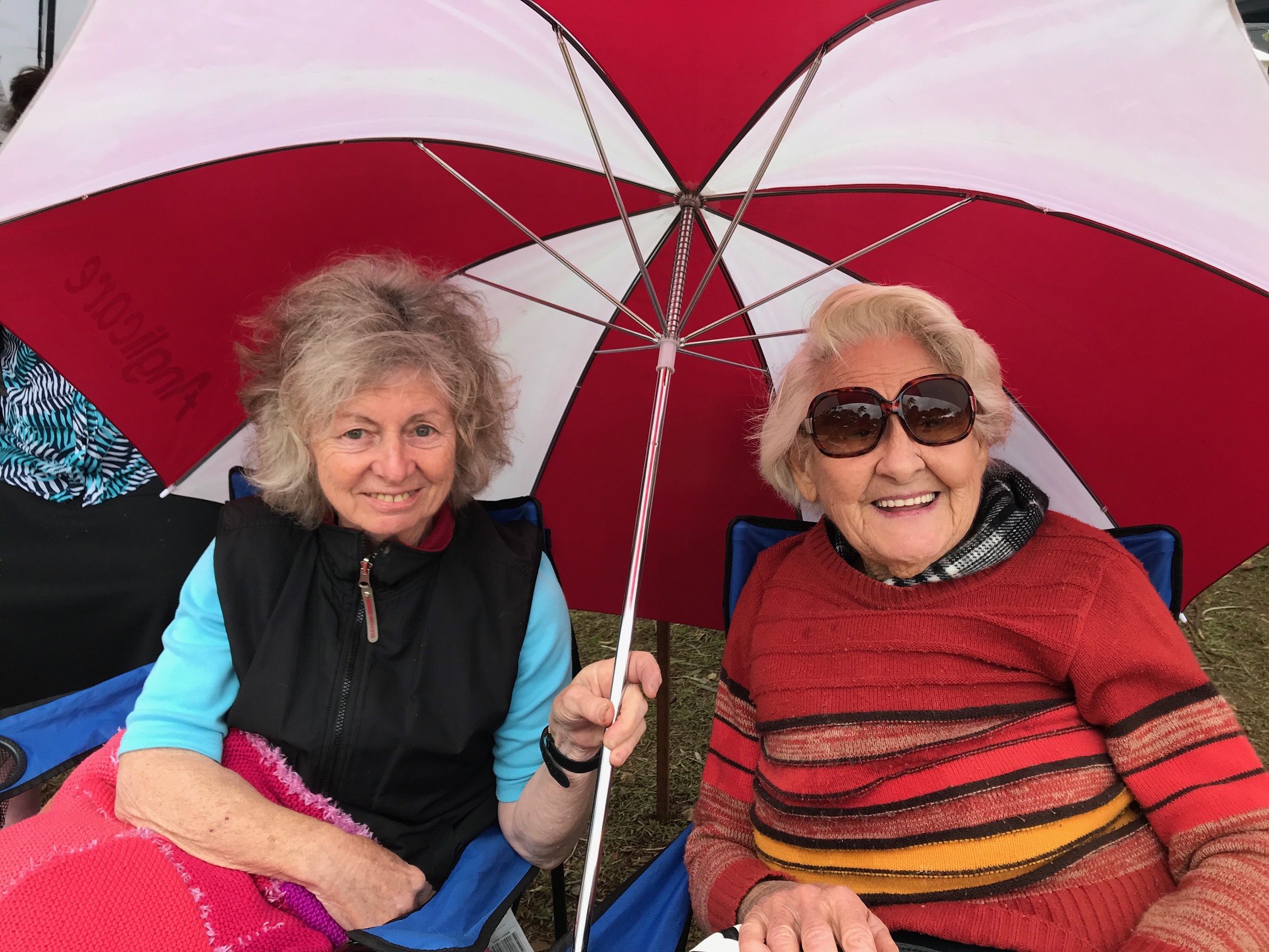 Two clients posed for a photo under an umbrella at Booin Gari Festival