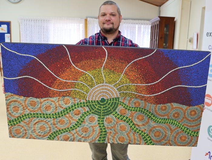 Kye Lane-Hart with his sunset painting at Symes Thorpe. 