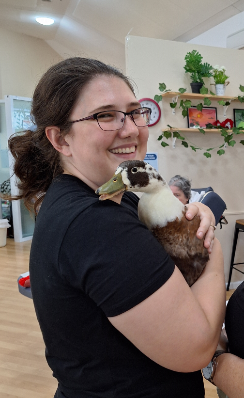 Lorna, Diversional Therapist, holding a duck.