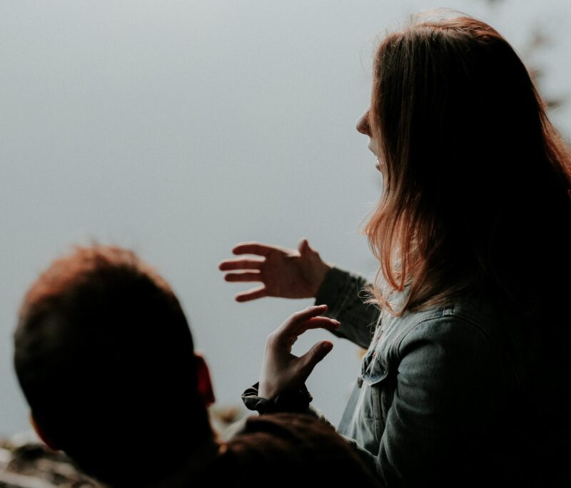 Two people within a yarning circle having a conversations