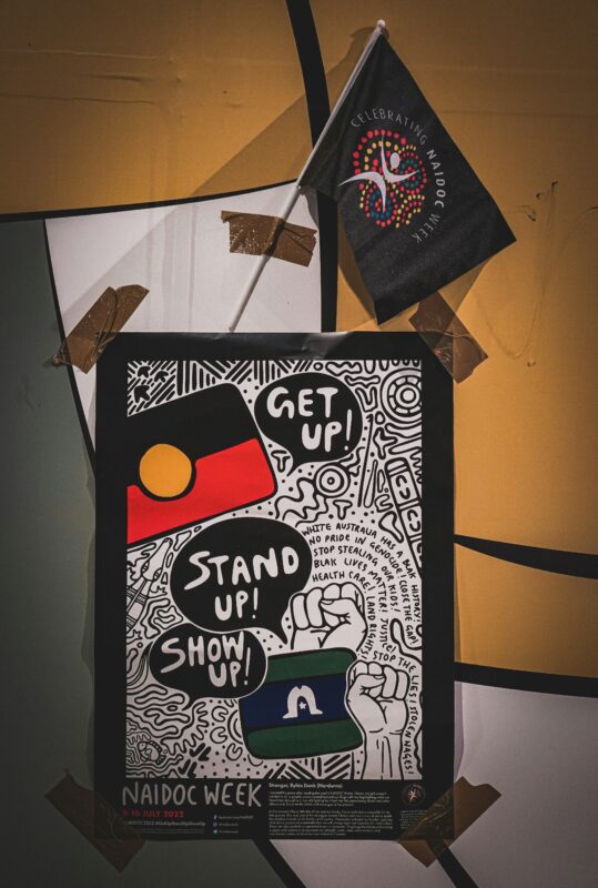 NAIDOC Week poster and flag from 2022