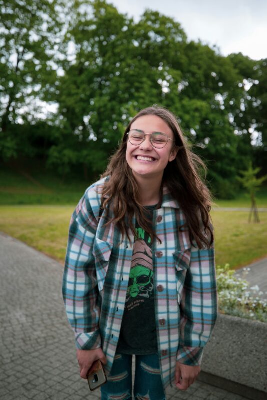 Young person smiling at camera expressing personal identity