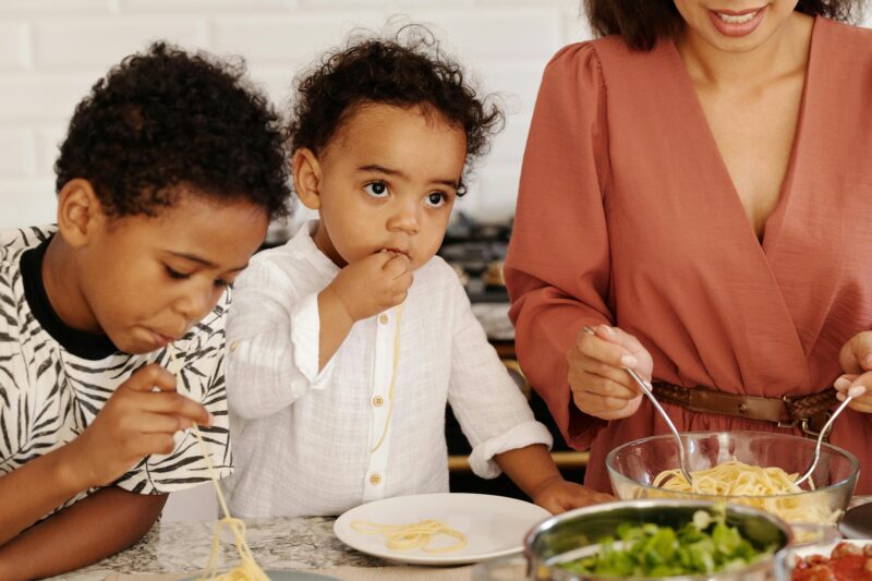 Mother meal prepping with two children