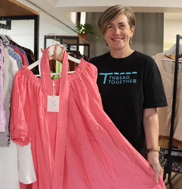 Thread Together volunteers with new dress.